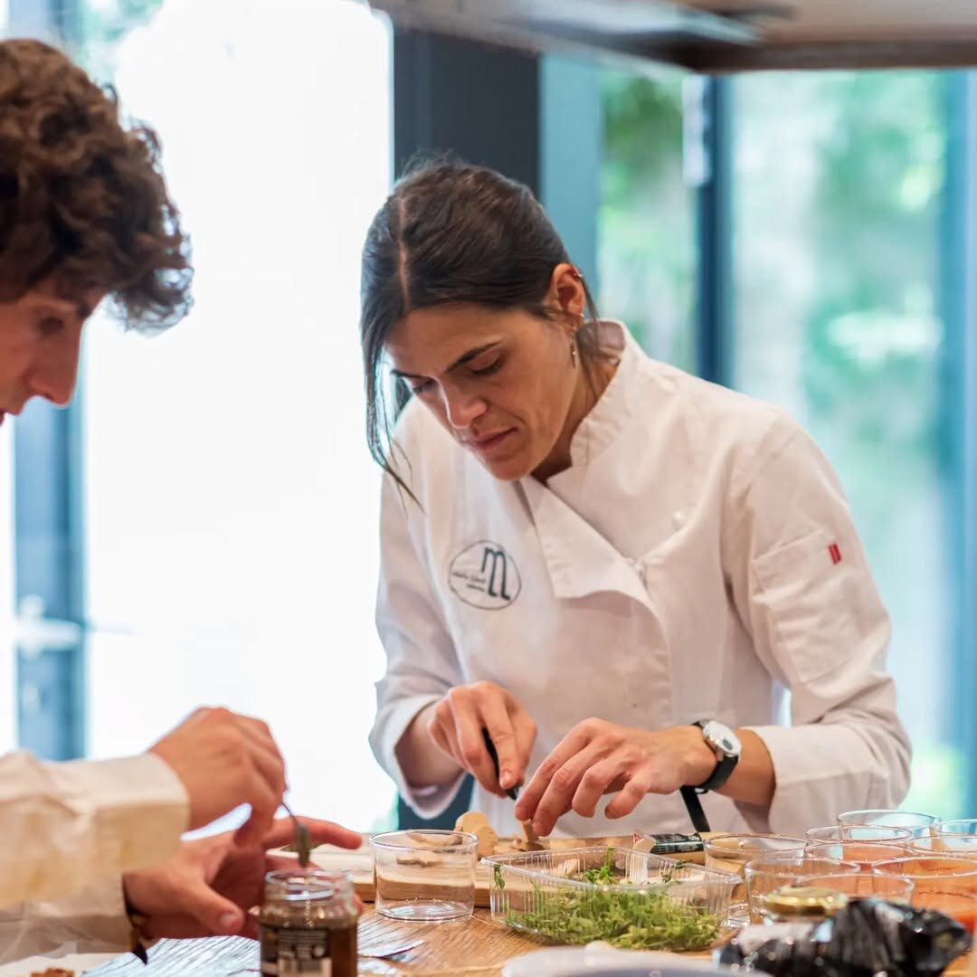 María Lluch, founder of María Lluch Catering, plating up in her chef's jacket