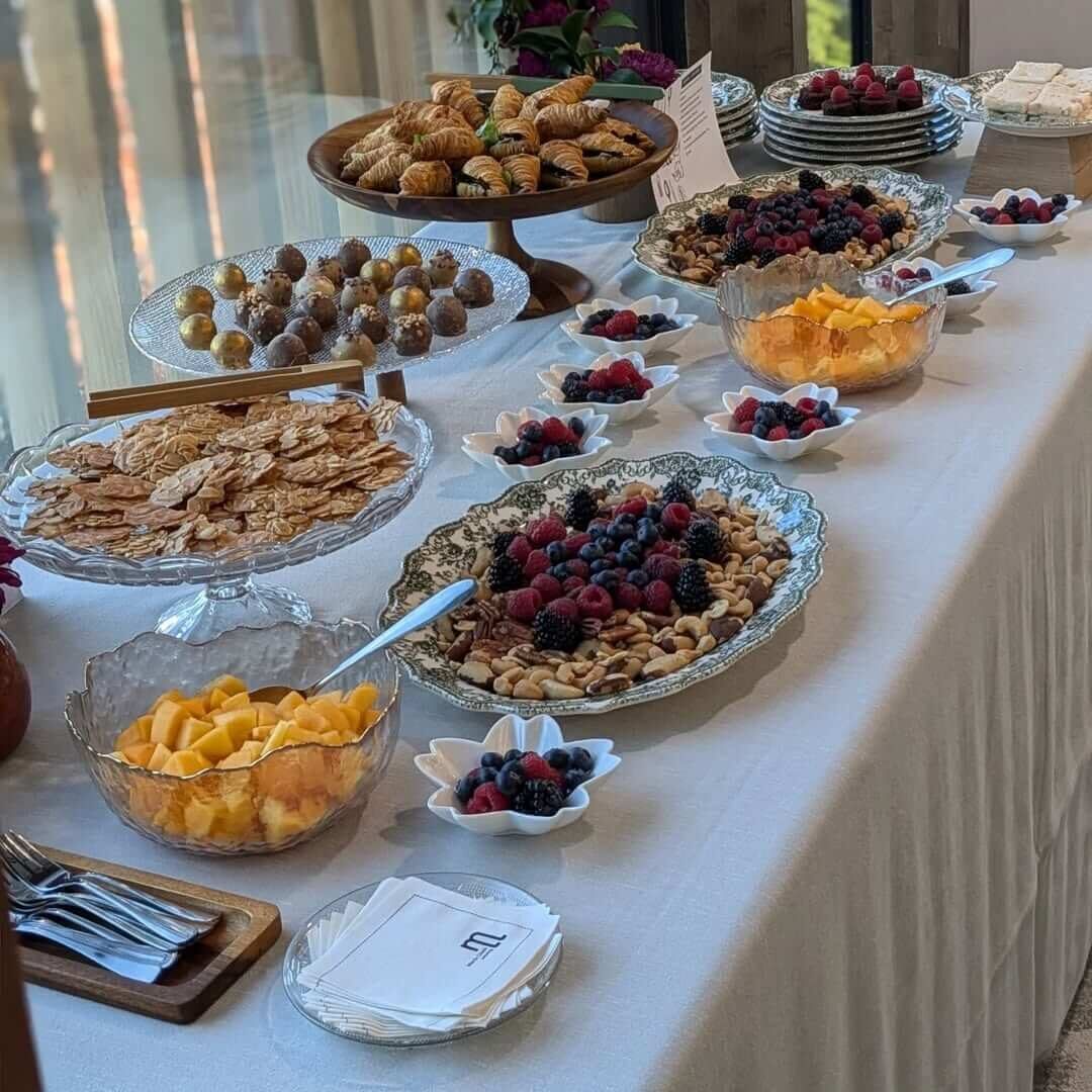 Breakfast table with sweet treats, mini croissants, fruit and nuts, María Lluch catering in Madrid