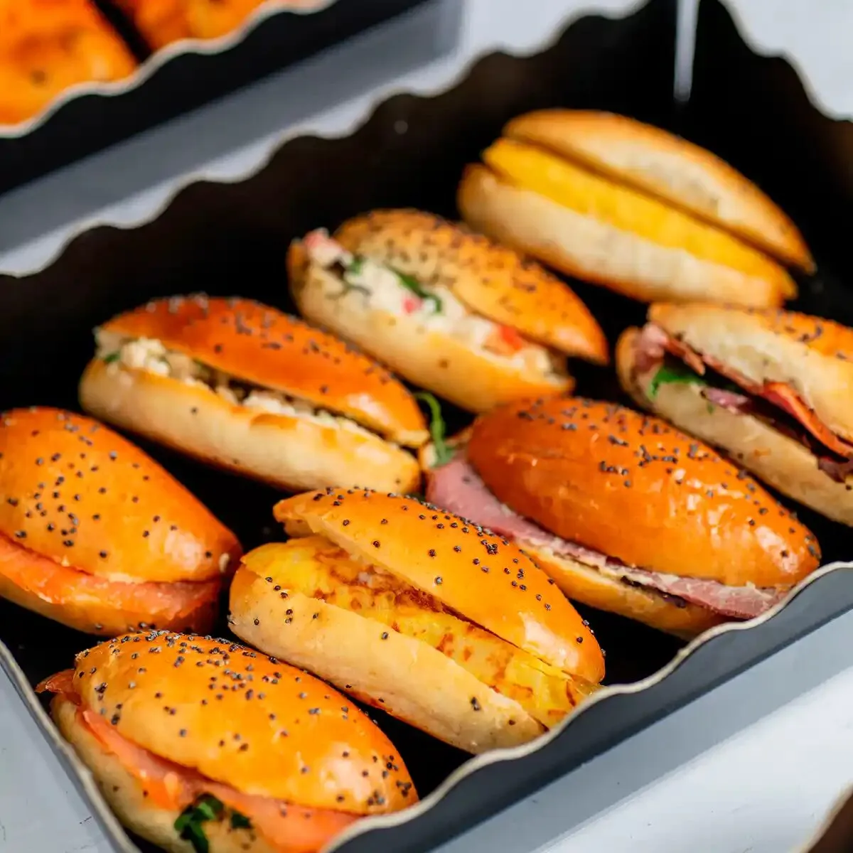 Assorted mini baguettes with salmon, ham and Spanish omelette for a coffee break, María Lluch catering in Madrid